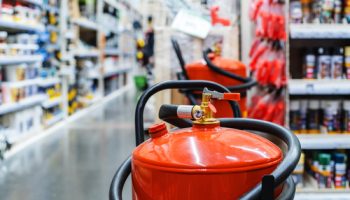 Large,Fire,Extinguishers,In,A,Shopping,Center,Against,The,Backdrop